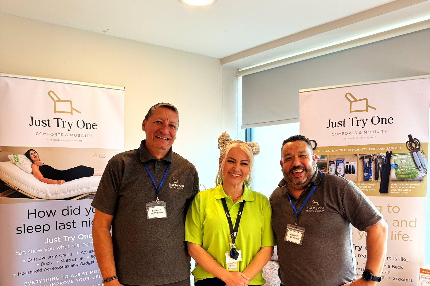 Zone experts and a Heyday team member sharing a laugh at their stand