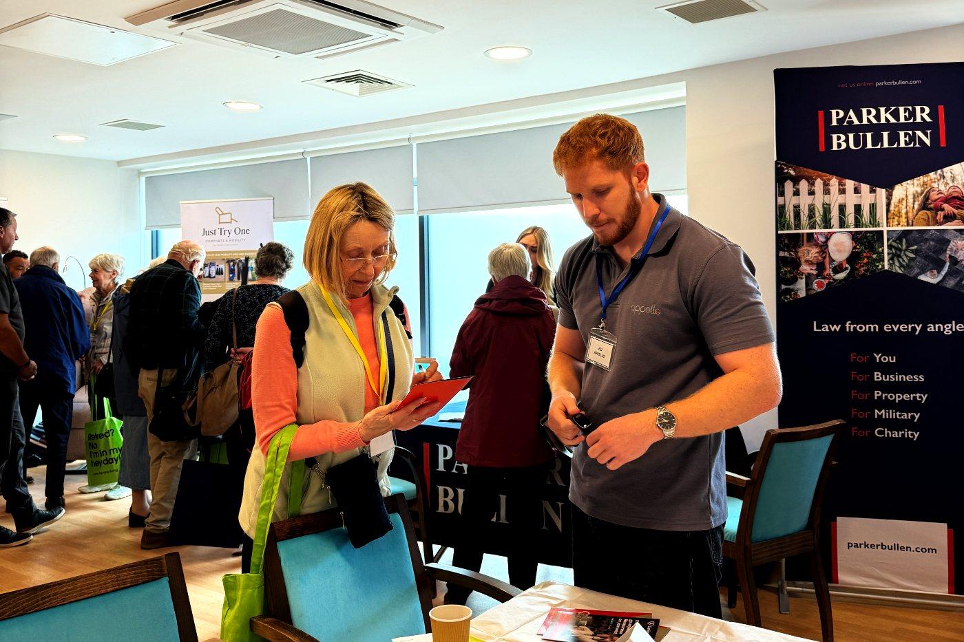 Visitors and zone experts mid-conversation in a busy zone room